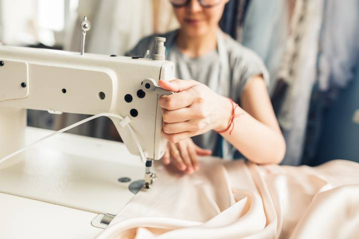 woman sewing on fabric