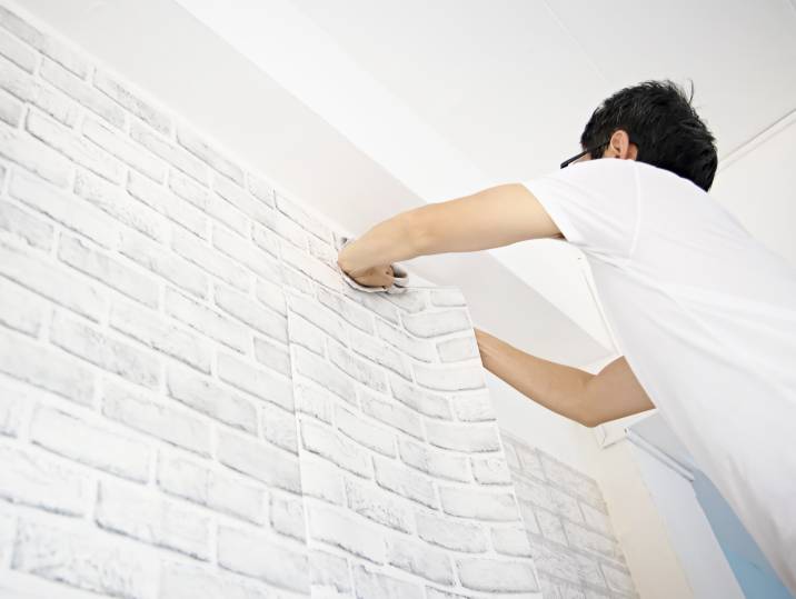 a man installing wallpaper