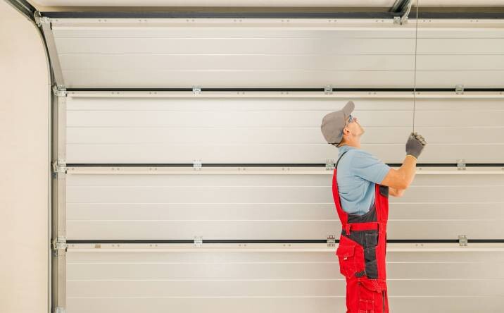 a handyman installing a garage door