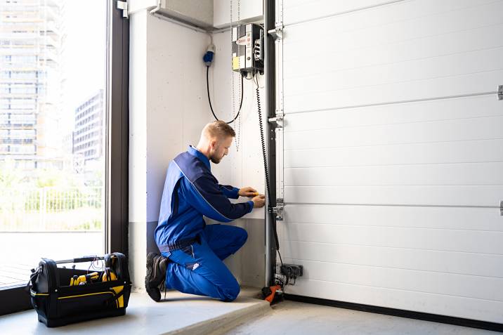 a handyman installing an automatic garage door