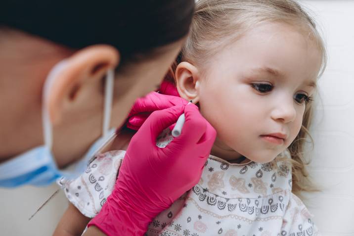 little girl getting ready to get ear piercings