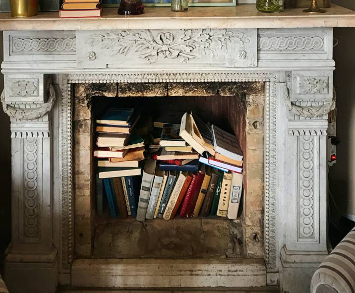 Unused fireplace as book nook