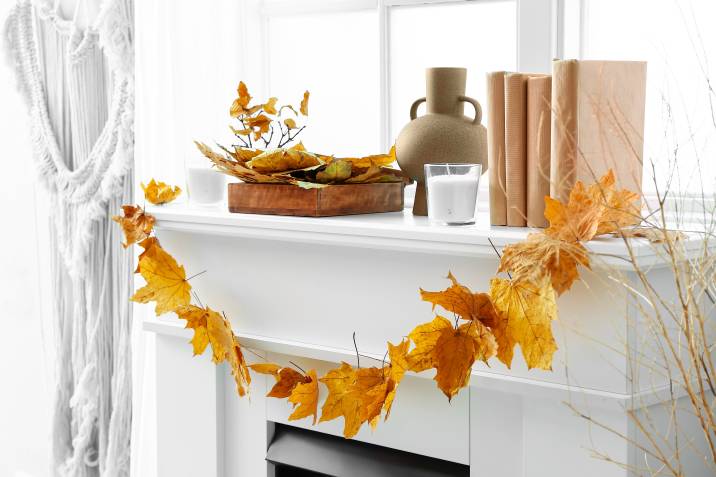 Dried foliage on empty fireplace mantel