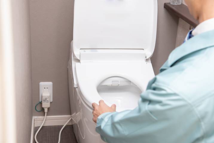 Inspecting toilet during quarterly home maintenance