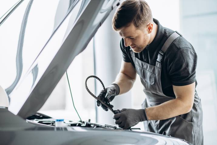 a man installing a new timing belt