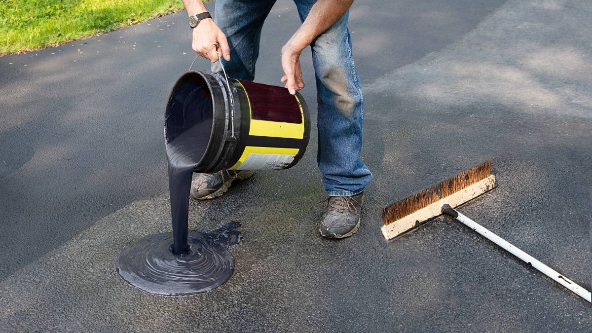 Applying a protective sealant to an asphalt driveway helps maintain its durability and appearance.