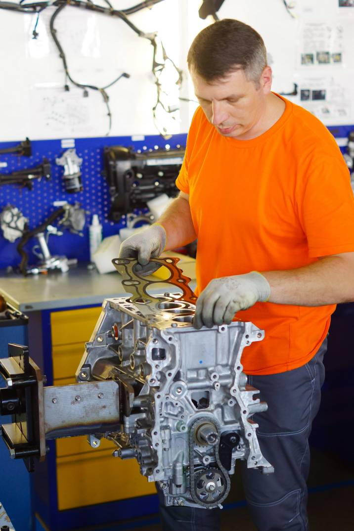 a mechanic with a cylinder head gasket