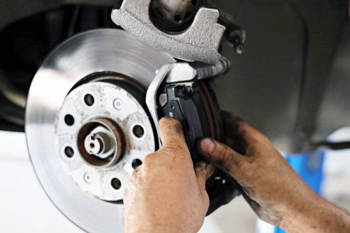 a mechanic installing new brake pads