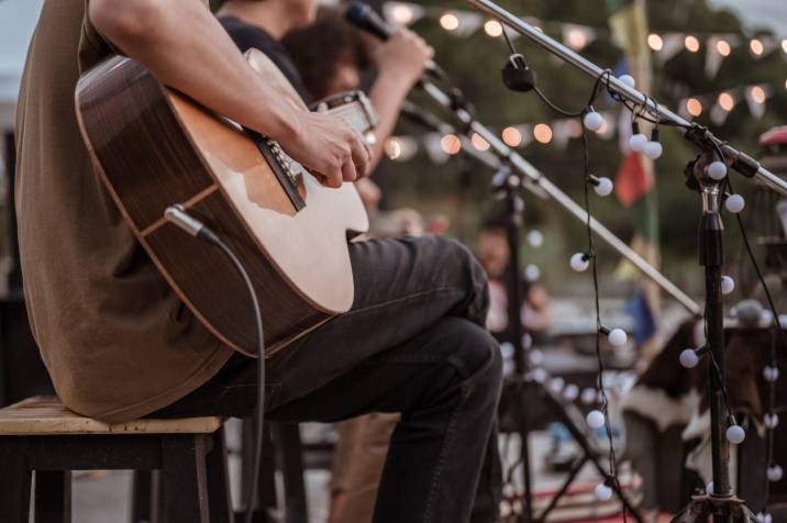 musician playing guitar at a live gig