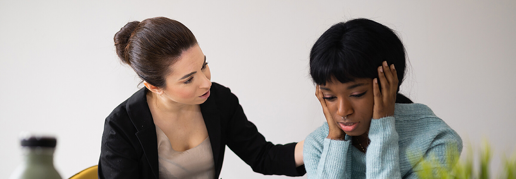 A person sitting on a couch, talking to a counselor, seeking support and guidance.