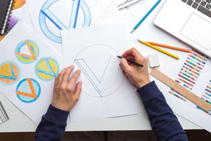 a designer sketching a logo