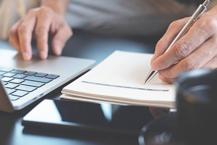 a man creating a posting schedule