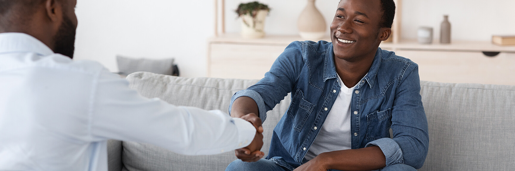 A person sitting on a couch in a therapy session, talking to a therapist, with a calm and peaceful atmosphere.