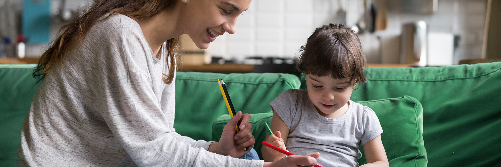 A smiling babysitter playing with a happy child, creating a joyful and safe environment for them.