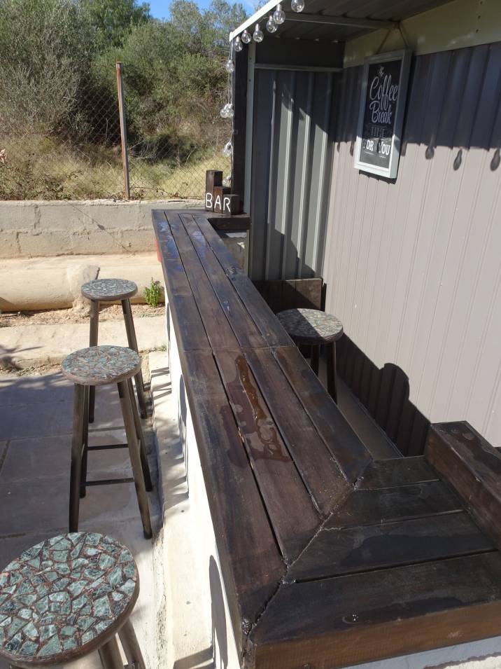 A garden shed bar featuring a polished wooden counter