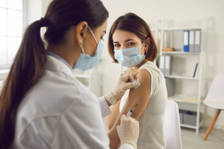 nurse administering a vaccine