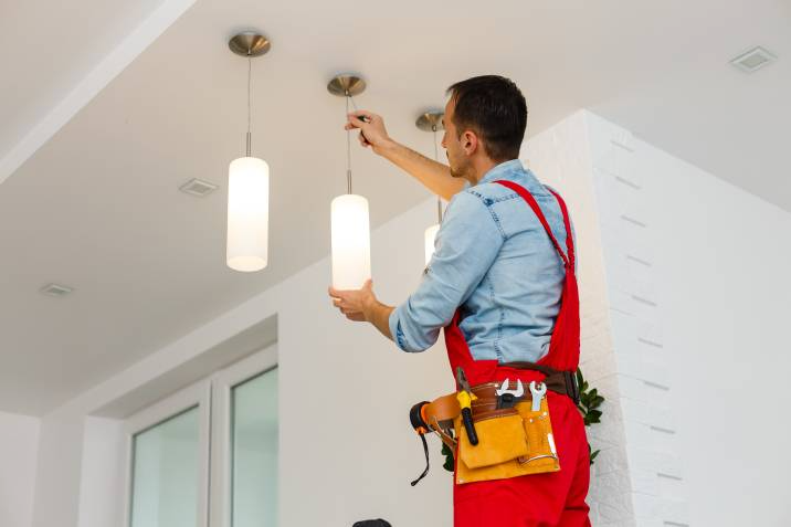 electrician installing light fixtures