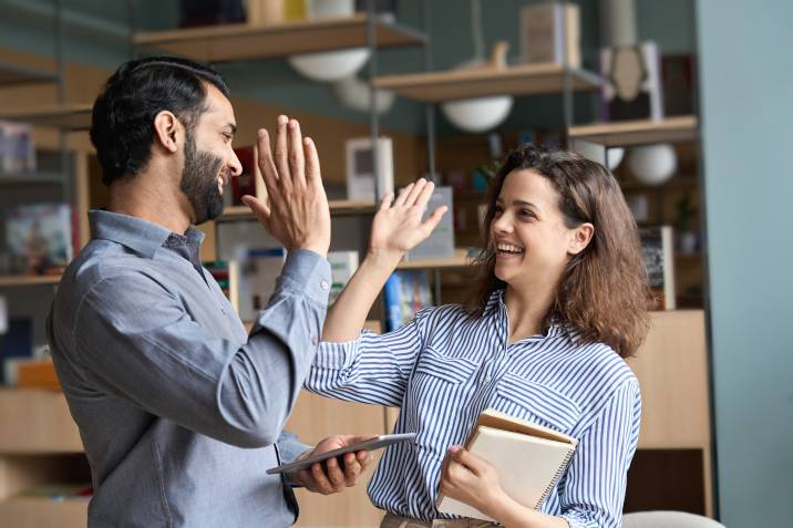 admin and her boss sharing a high five