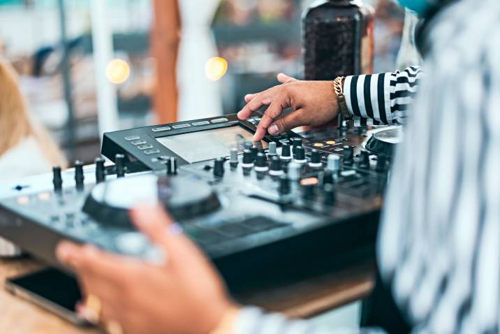 a DJ using a sound mixer