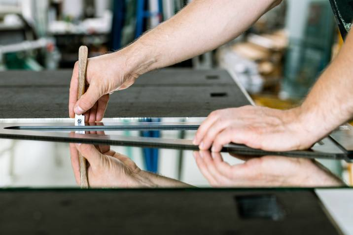 person cutting a mirror