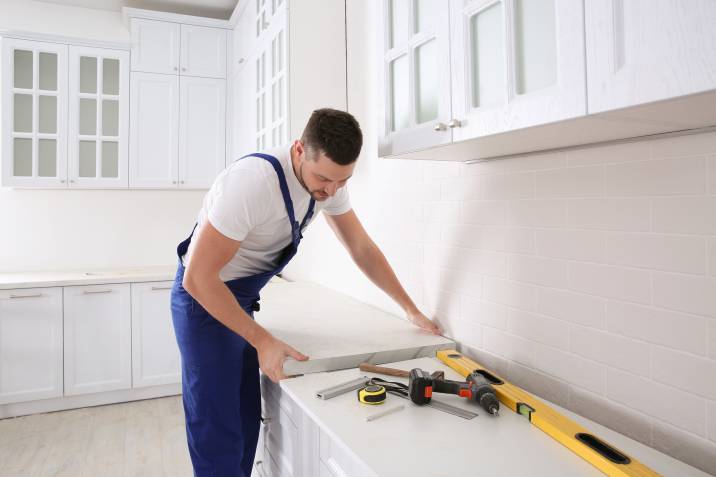 a handyman installing a new kitchen countertop