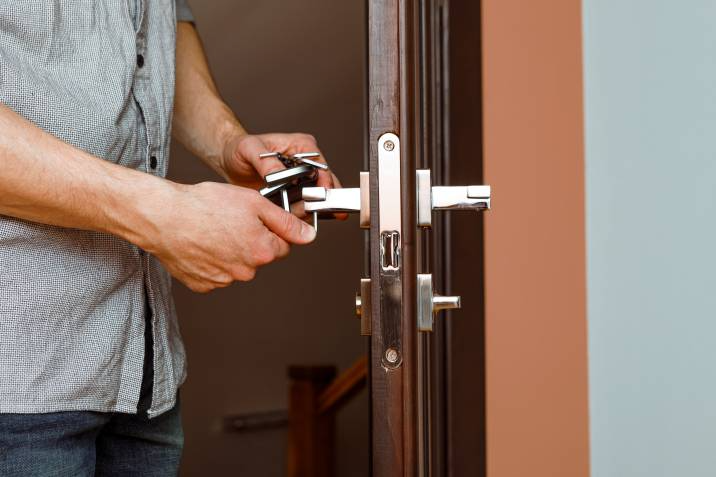 person turning a door handle set