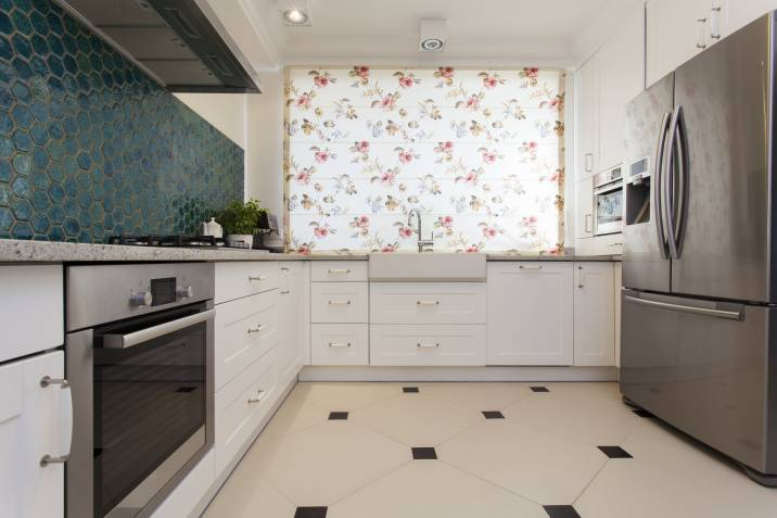 window blinds pattern contrasts the kitchen wall