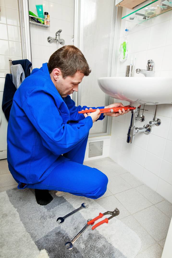 a-plumber-repairing-a-broken-bathroom-sink