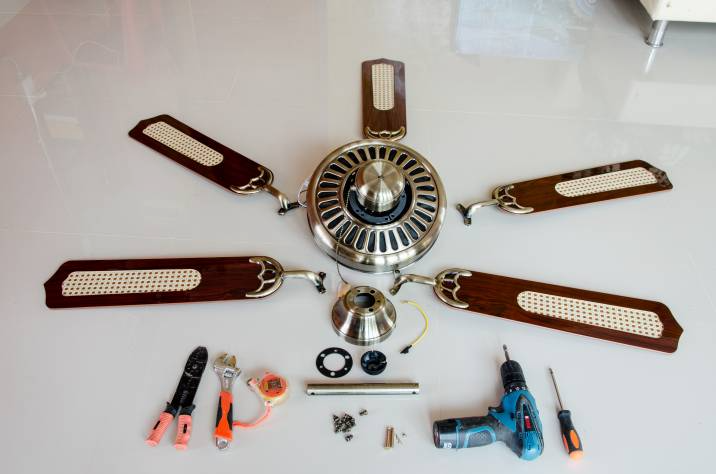 disassembled ceiling fan and tools