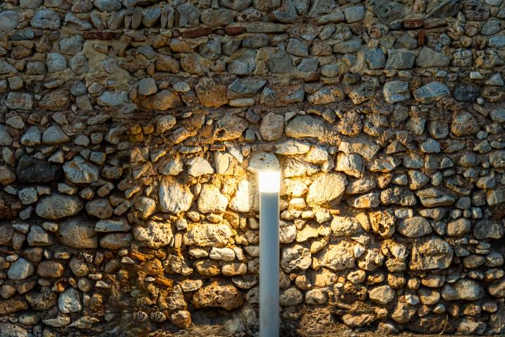 bollard lamp illuminating a stone wall