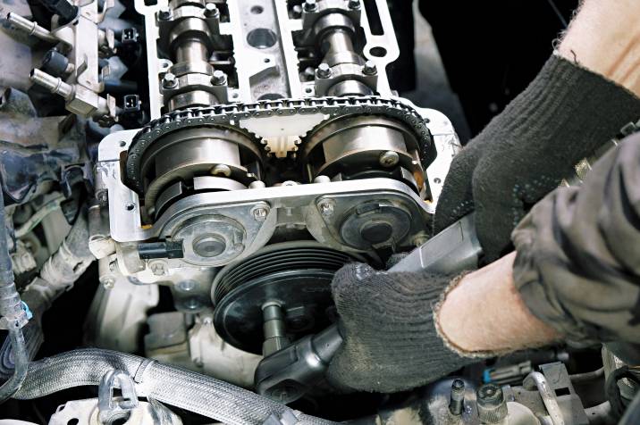 a mechanic replacing a car engine