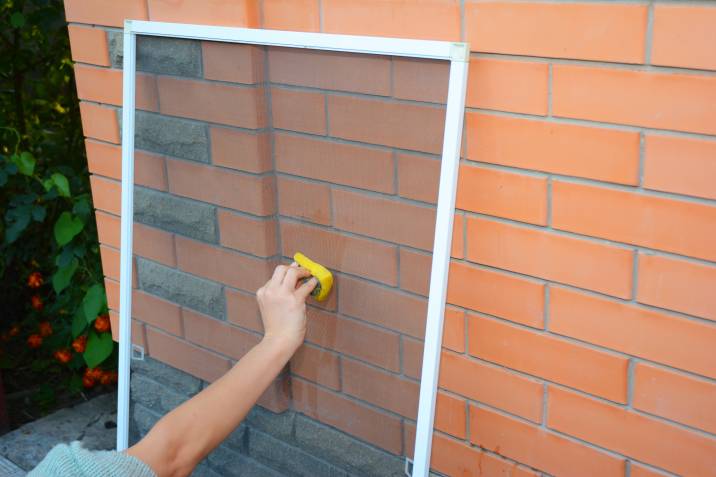 Cleaning window wire screen with a sponge