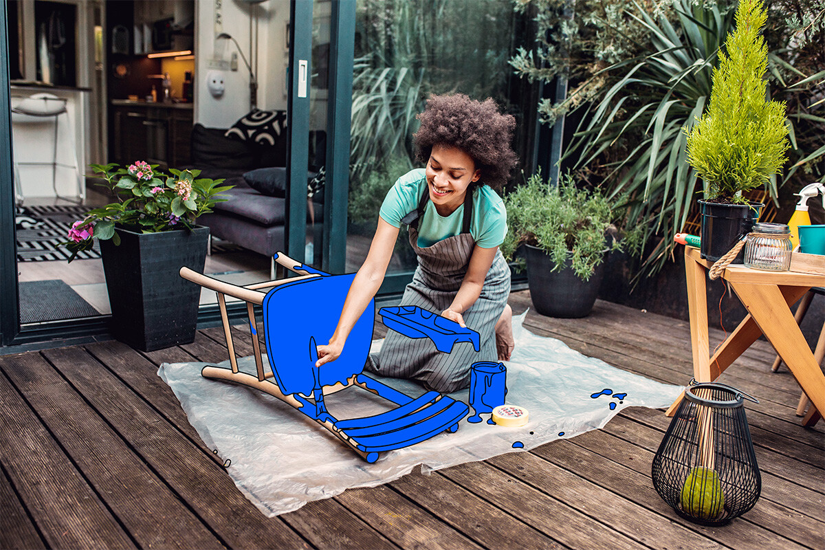 Creative woman painting a chair with a vibrant color, adding a unique touch of artistry and transforming its appearance.