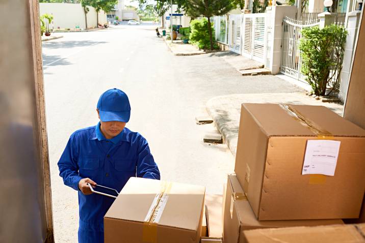 a removalist loading boxes into a truck