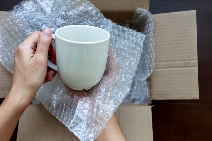 mug being wrapped in bubble wrap