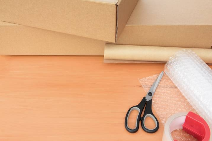 Packaging materials for moving a mirror. Bubble wrap, boxes, tape, scissors