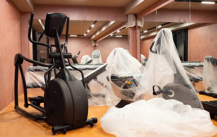 elliptical and other gym equipment packed in protective film