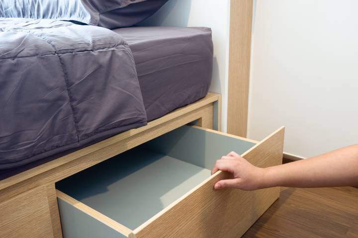 person removing the other parts of a bed frame
