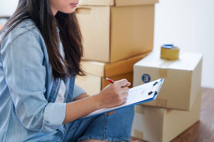 homeowner reviewing her moving inventory checklist