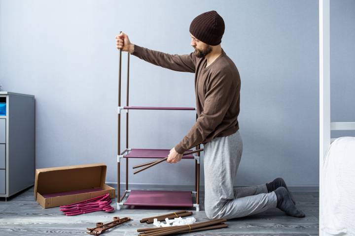 man disassembling furniture