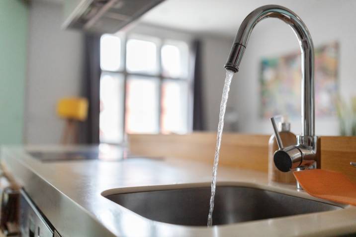 a kitchen faucet with water running from the tap