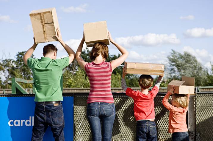 a family holding boxes