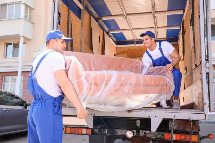 loading a sofa in a moving truck