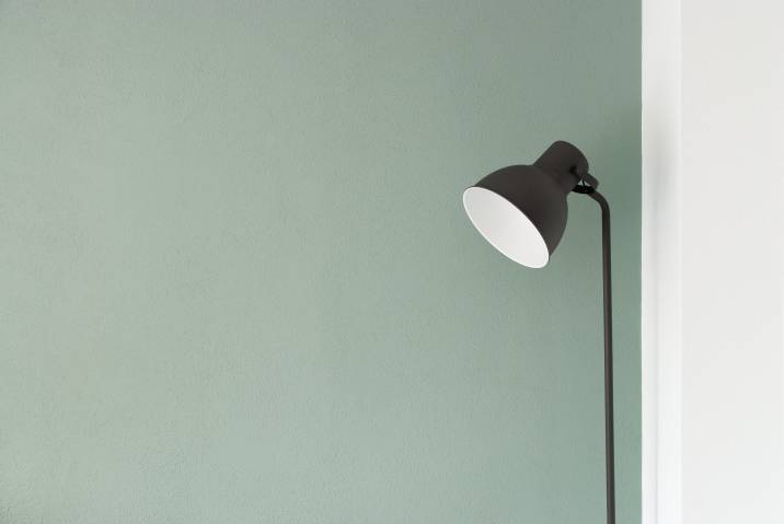 Flat matte paint finish, floor lamp near a light green wall