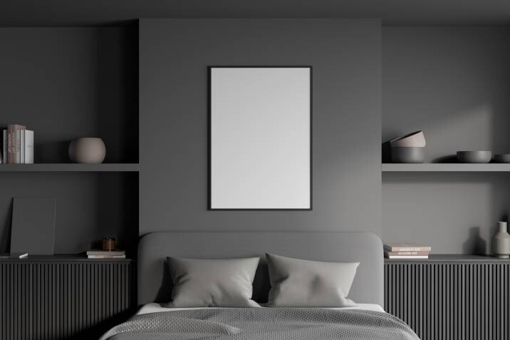 Grey bed and walls. White poster over a headboard, two symmetric shelves with ledges of wood