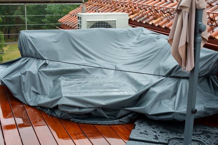 patio furniture cover protecting couch from the rain