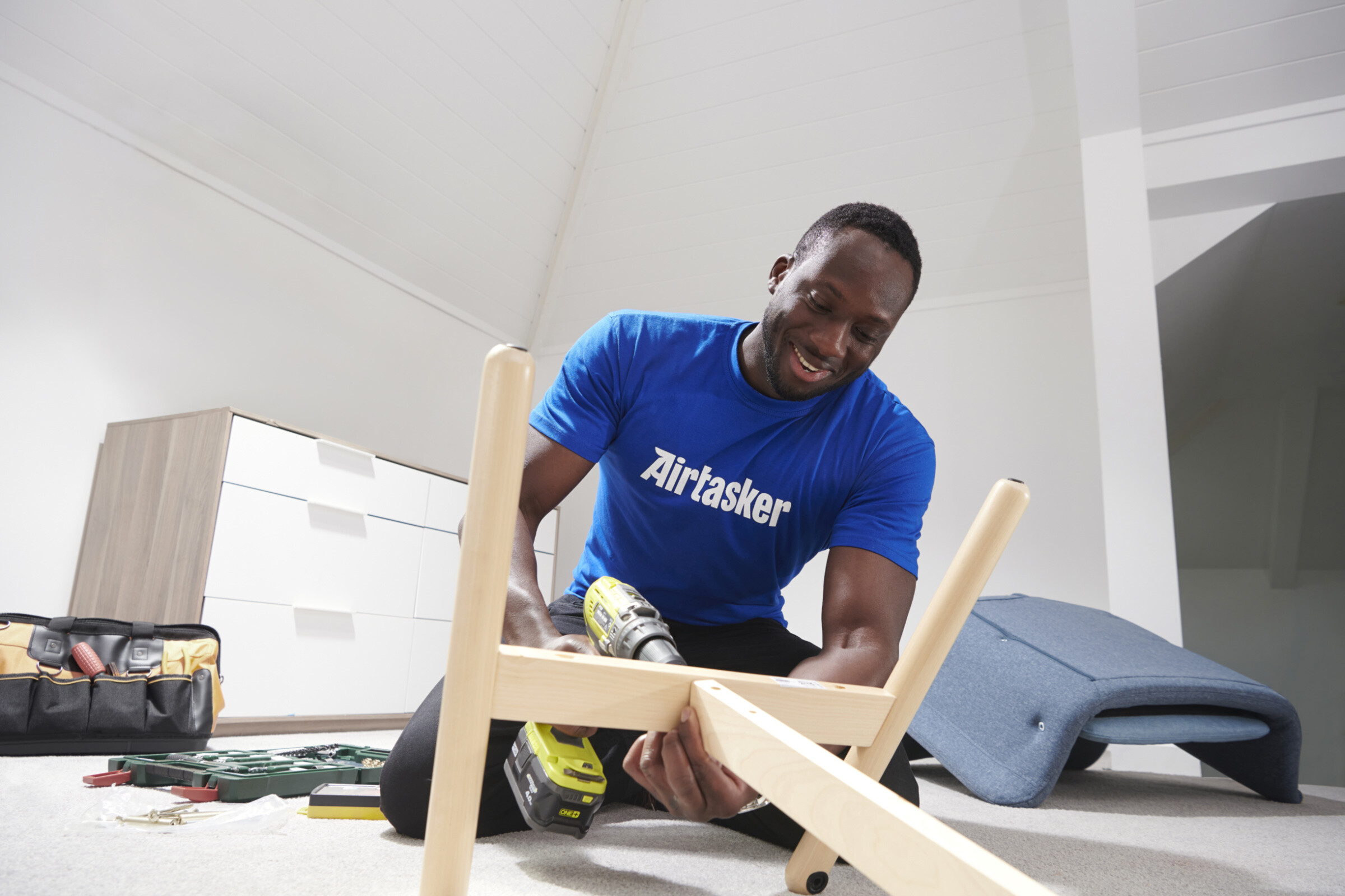 A skilled furniture assembly expert working diligently to assemble a piece of furniture with precision and expertise.