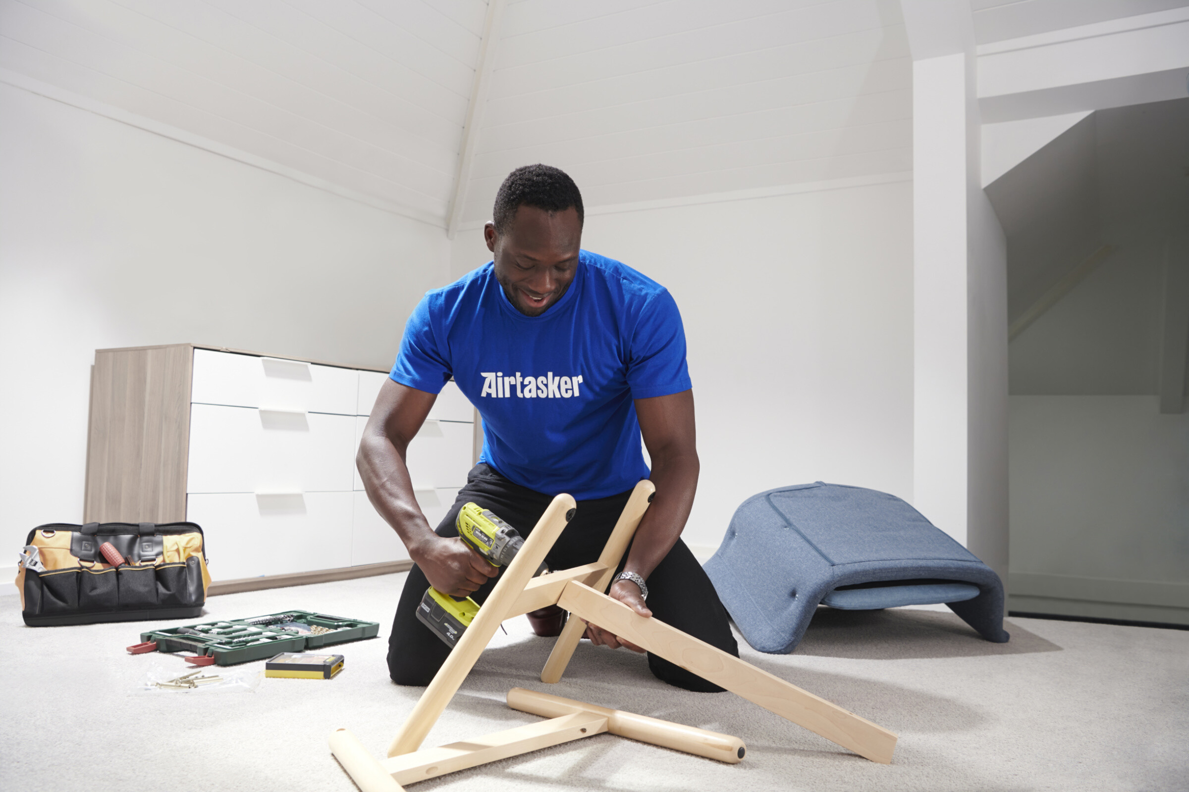 A person assembling furniture from IKEA, surrounded by various tools and parts, creating a cozy and organized living space.