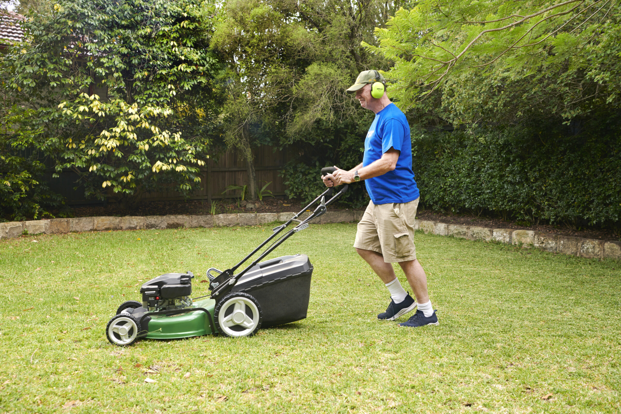 A professional lawn mower parked on a green lawn, ready to be used for cutting grass.