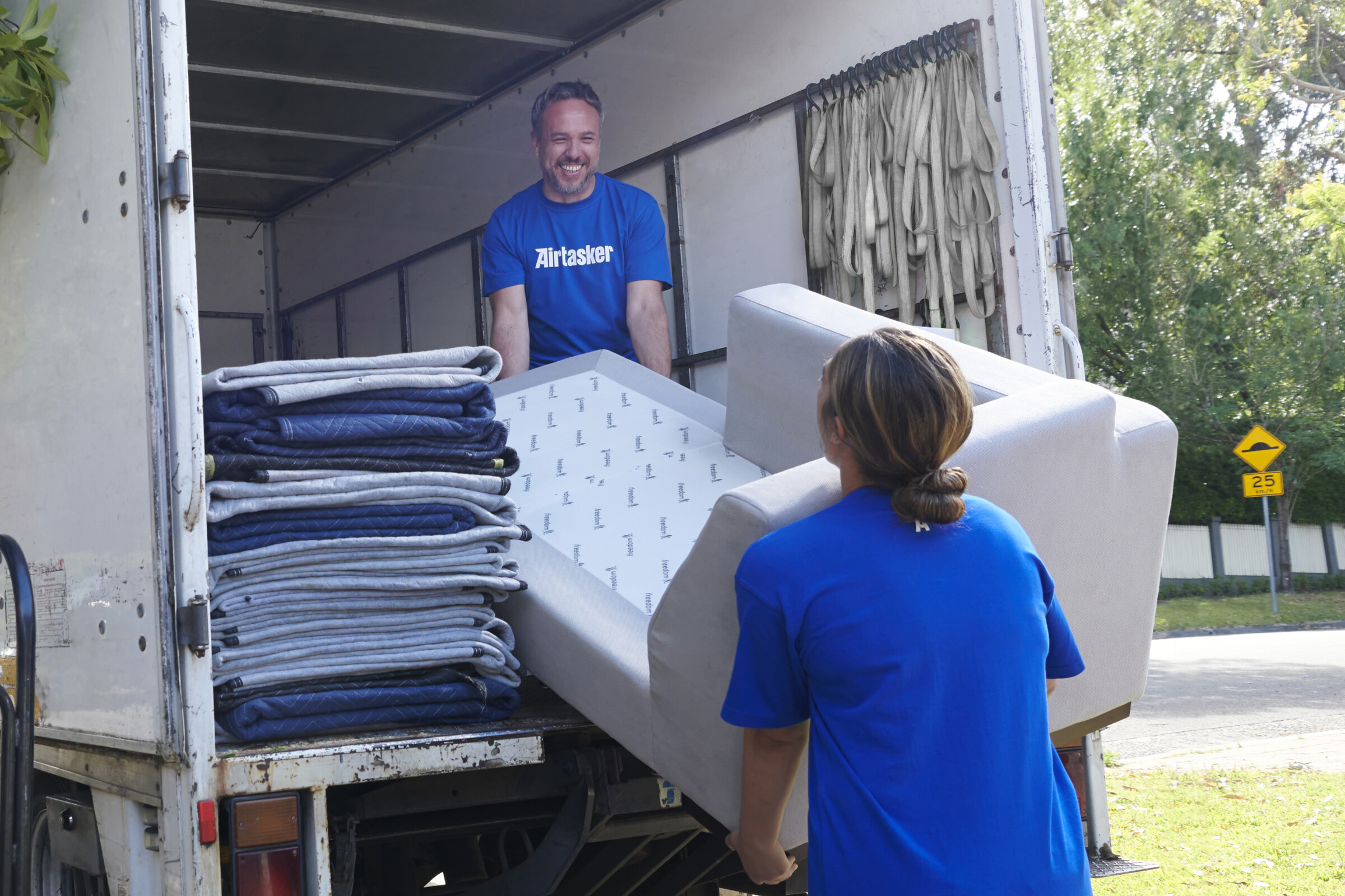 A moving truck parked on a street, ready to transport belongings.